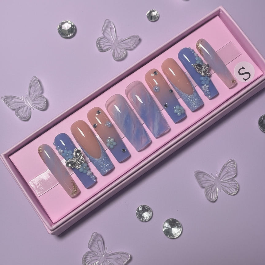 Set of colorful press-on nails with decorations in a pink box with butterflies and rhinestones on a purple background.