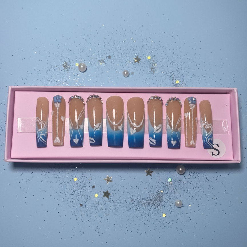 Set of gradient nail art designs in a pink box on a light blue background