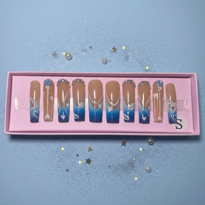 Set of gradient nail art designs in a pink box on a light blue background
