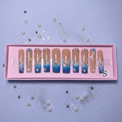 Set of gradient nail art designs in a pink box on a light purple background with decorative elements.
